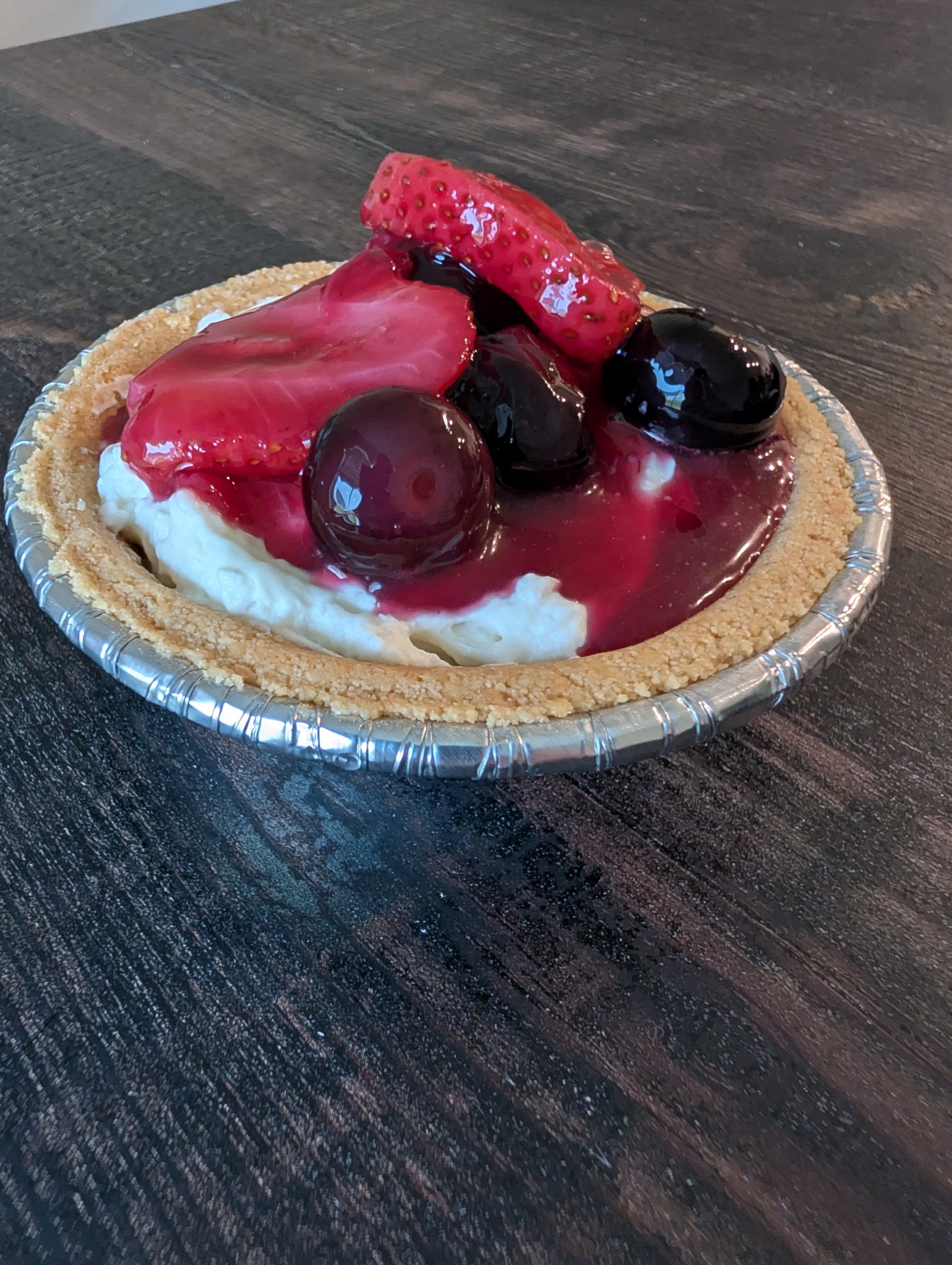 Mini cheesecakes topped with strawberries and blueberries